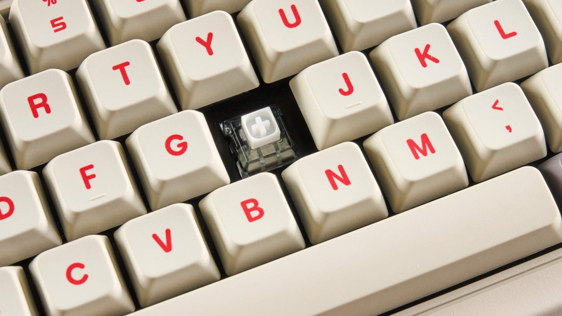 The 8BitDo Retro keyboard with a keycap removed, showing the fitted switch. Image: Nikita Achanta / Future.