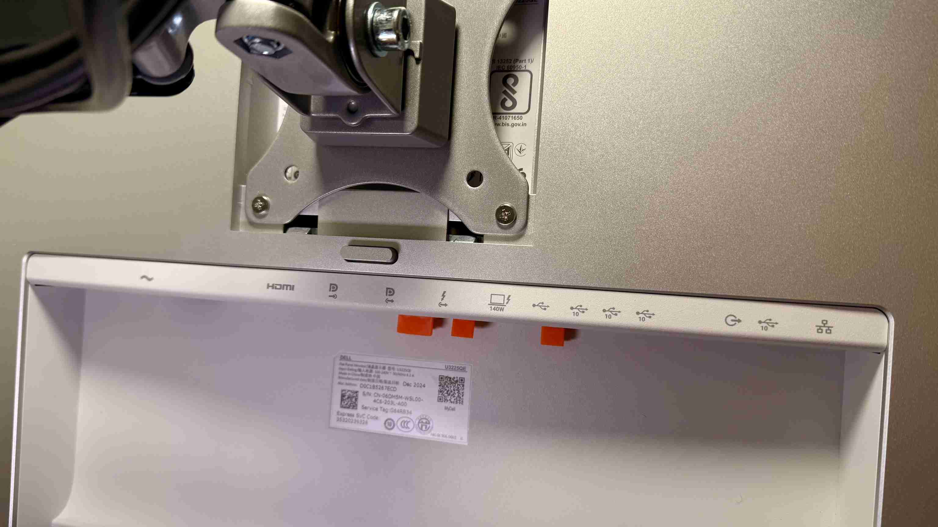 The Dell U3225QE mounted on an arm, with its rear connection area exposed. Image: Collin Probst / Future.