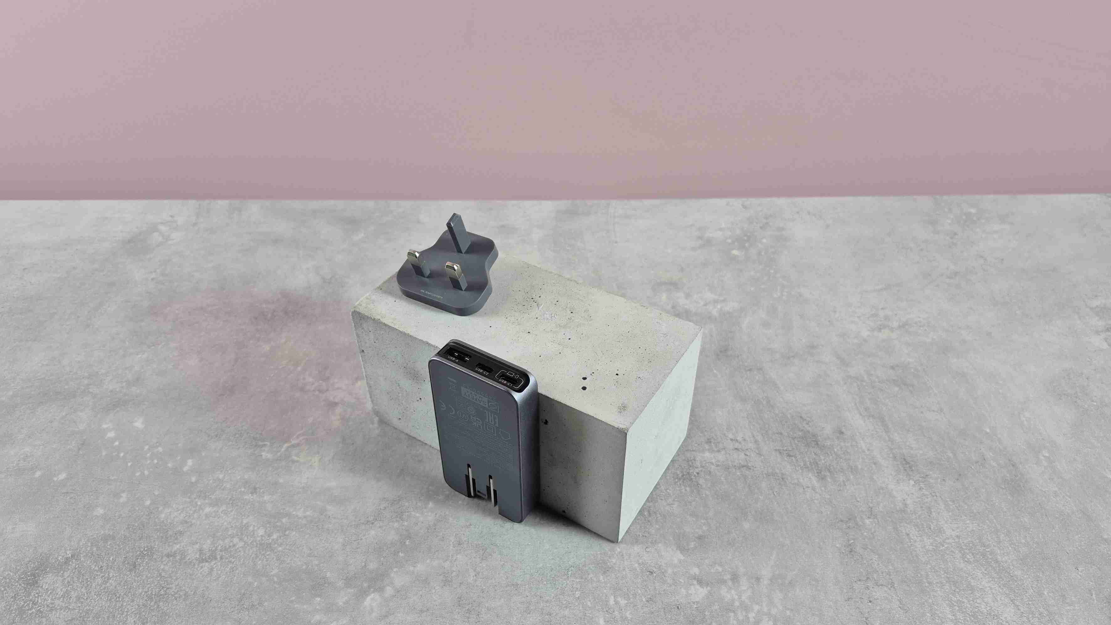 The UGreen Ultra-Slim charger beside its detached UK plug piece on a display block. Image: Harry Padoan / Future.