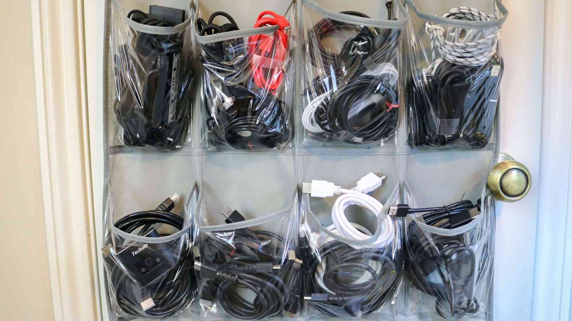 Spare cables separated into the transparent pockets of a hanging shoe organizer. Image: Future.