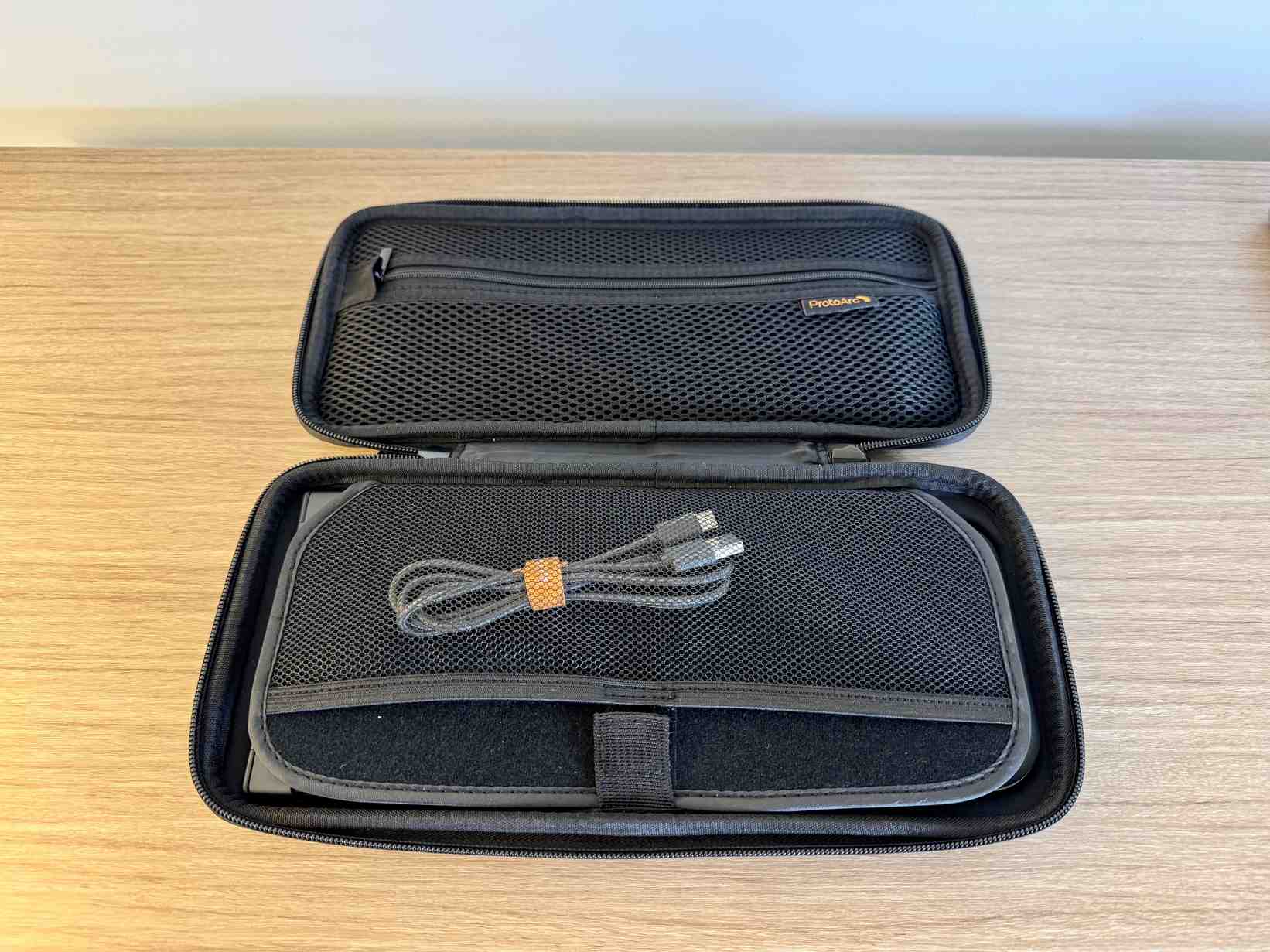 The opened ProtoArc CaseUp carrying case with mesh compartments and a cable inside. Image: Collin Probst / Future.