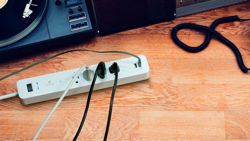 A power strip with several connected devices beside home entertainment equipment. Source illustration: Future.