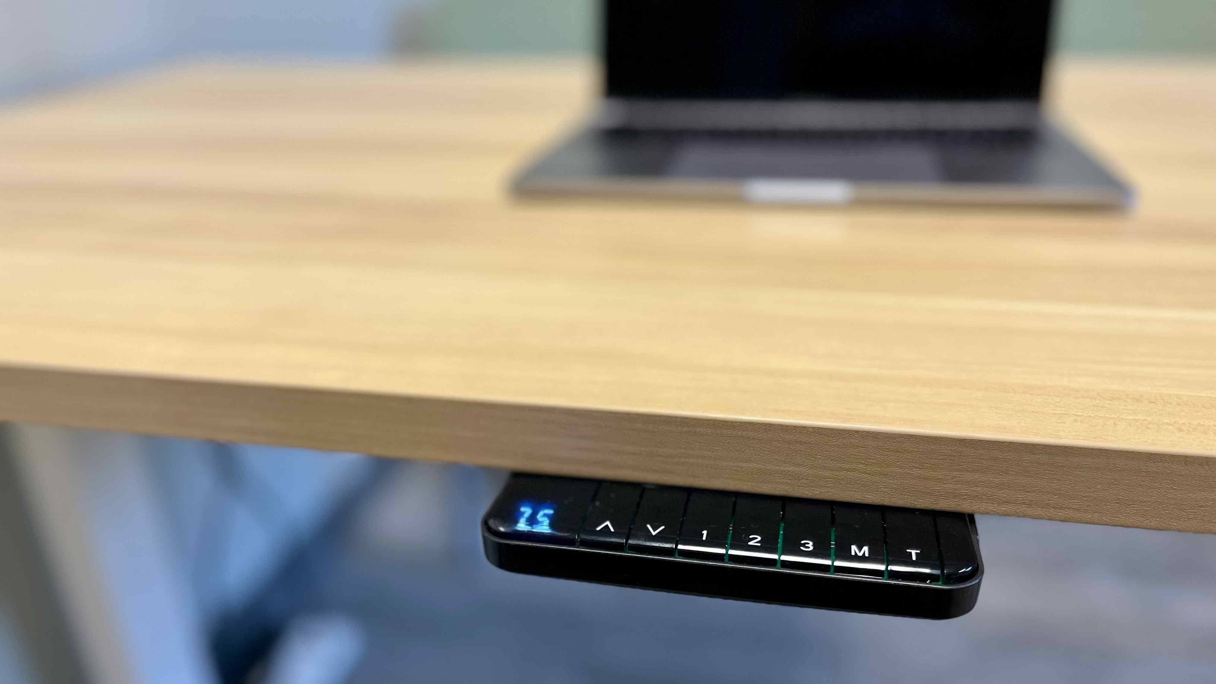 A closer view of the Mount-It desk's keypad beneath the worktop, with its saved-height buttons visible. Image: Collin Probst / Future.