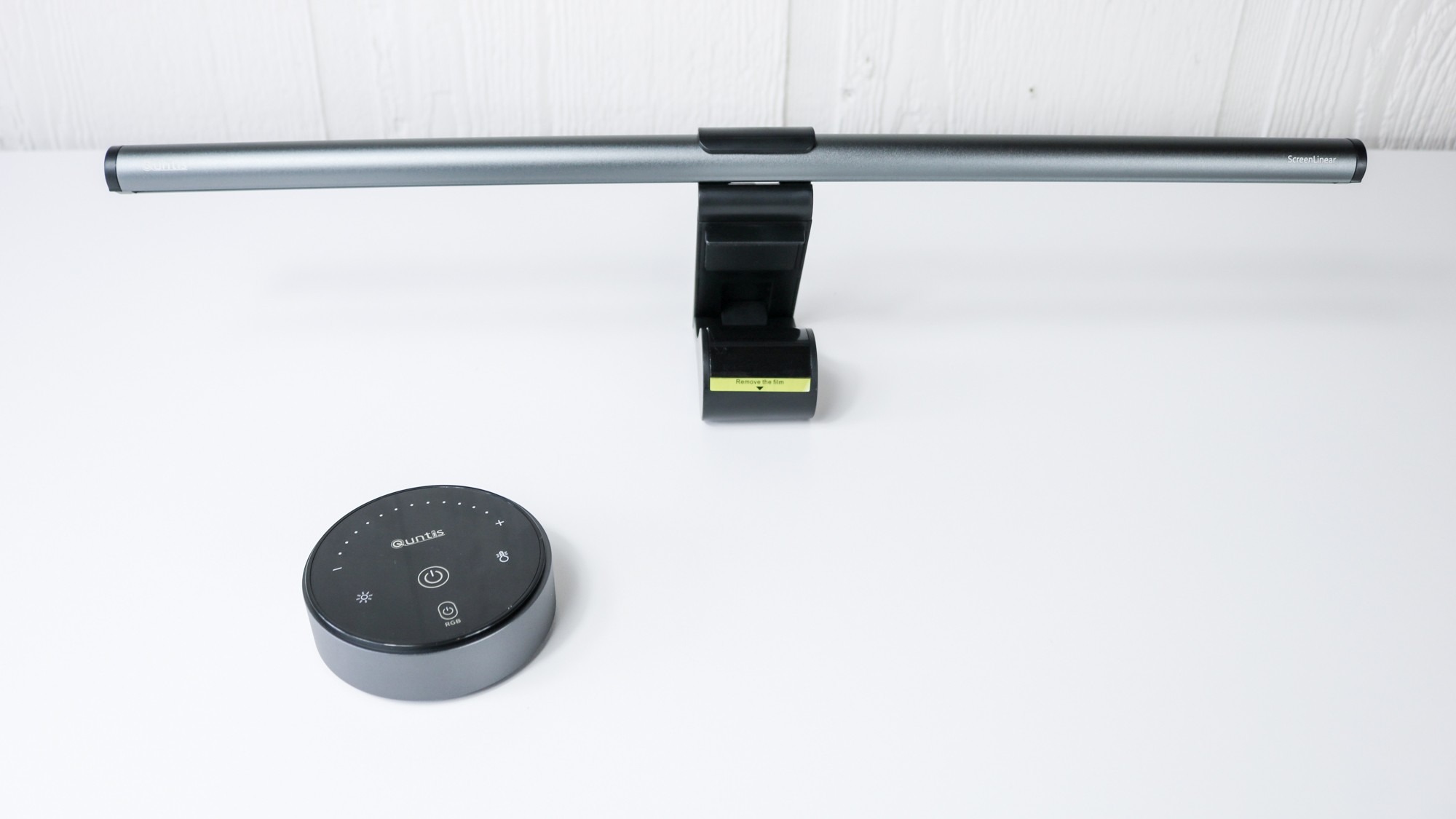 The Quntis RGB Pro+ light bar and its separate puck-shaped controller on a desk before installation. Image: Future.