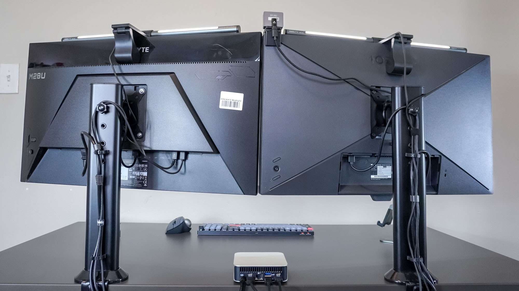 The rear of the two-monitor arrangement, showing separate clamp stands and routed cables. Image: Tom's Guide.