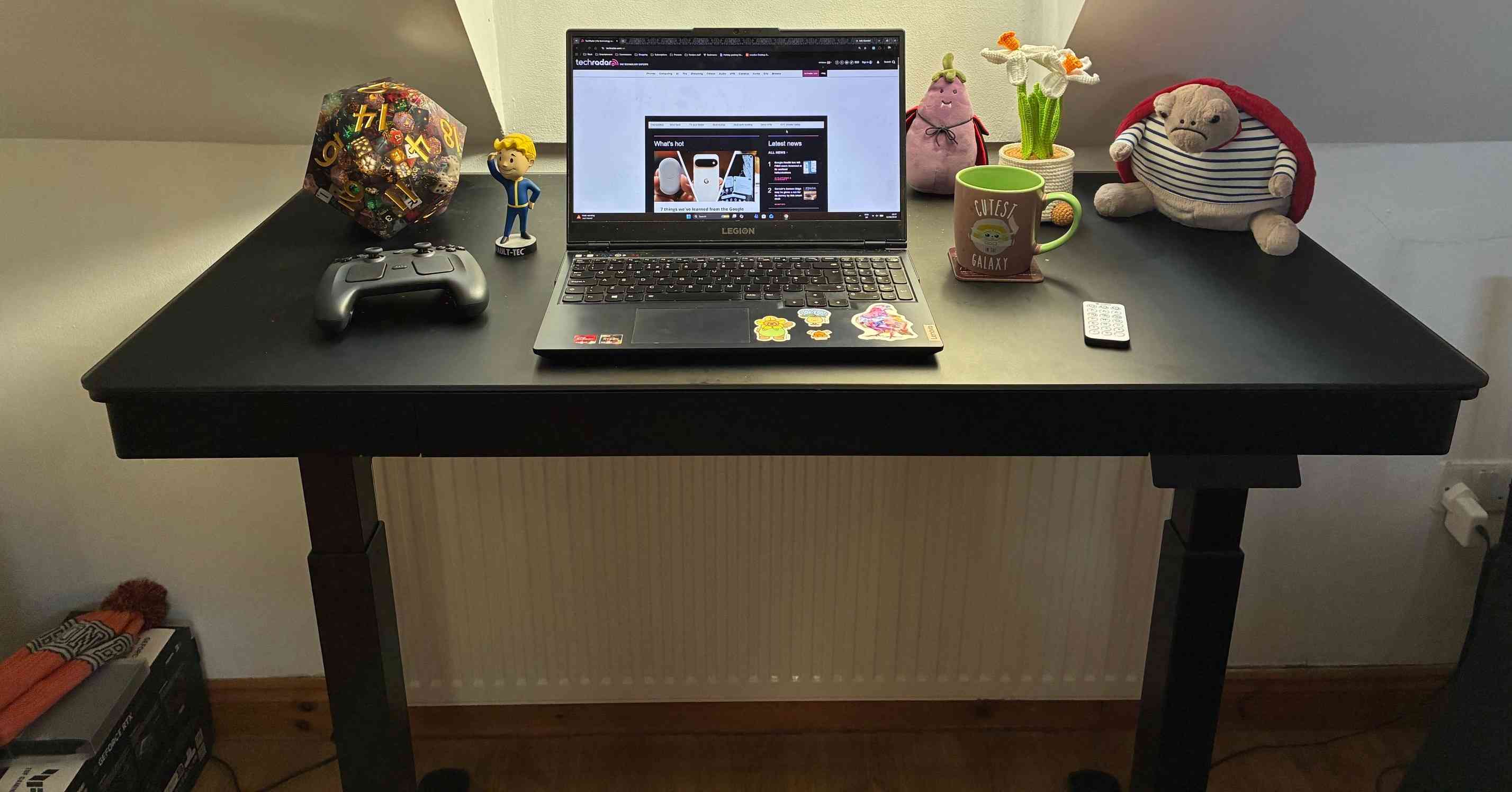 The Eureka Wonder Glowing Glass Desk raised for standing, with the laptop and accessories used in the review. Image: Lucy Buglass / Future.
