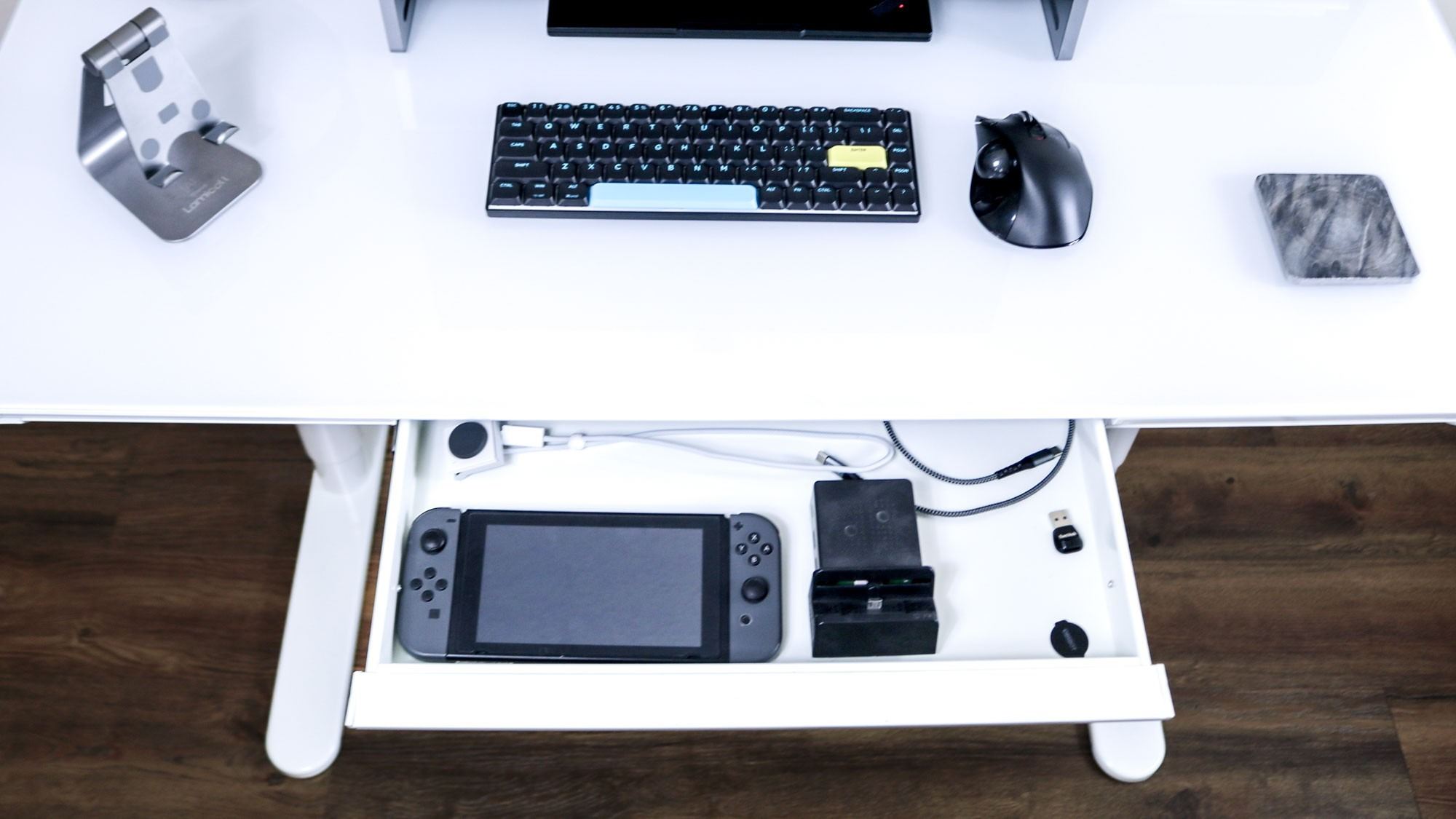The LiftSync Clear Plus drawer opened to show a Nintendo Switch and selected accessories in the source reviewer's arrangement. Image: Tom's Guide.