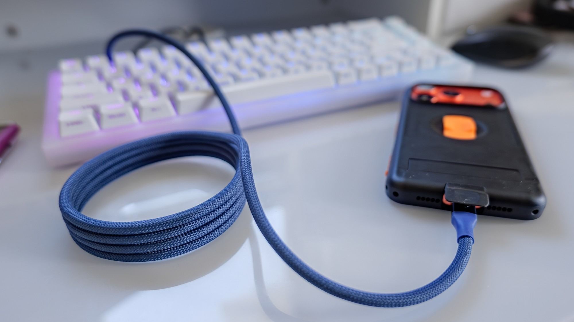 The blue braided MagStack lead connected to a phone, with its unused length gathered into a supported coil. Image: Future.