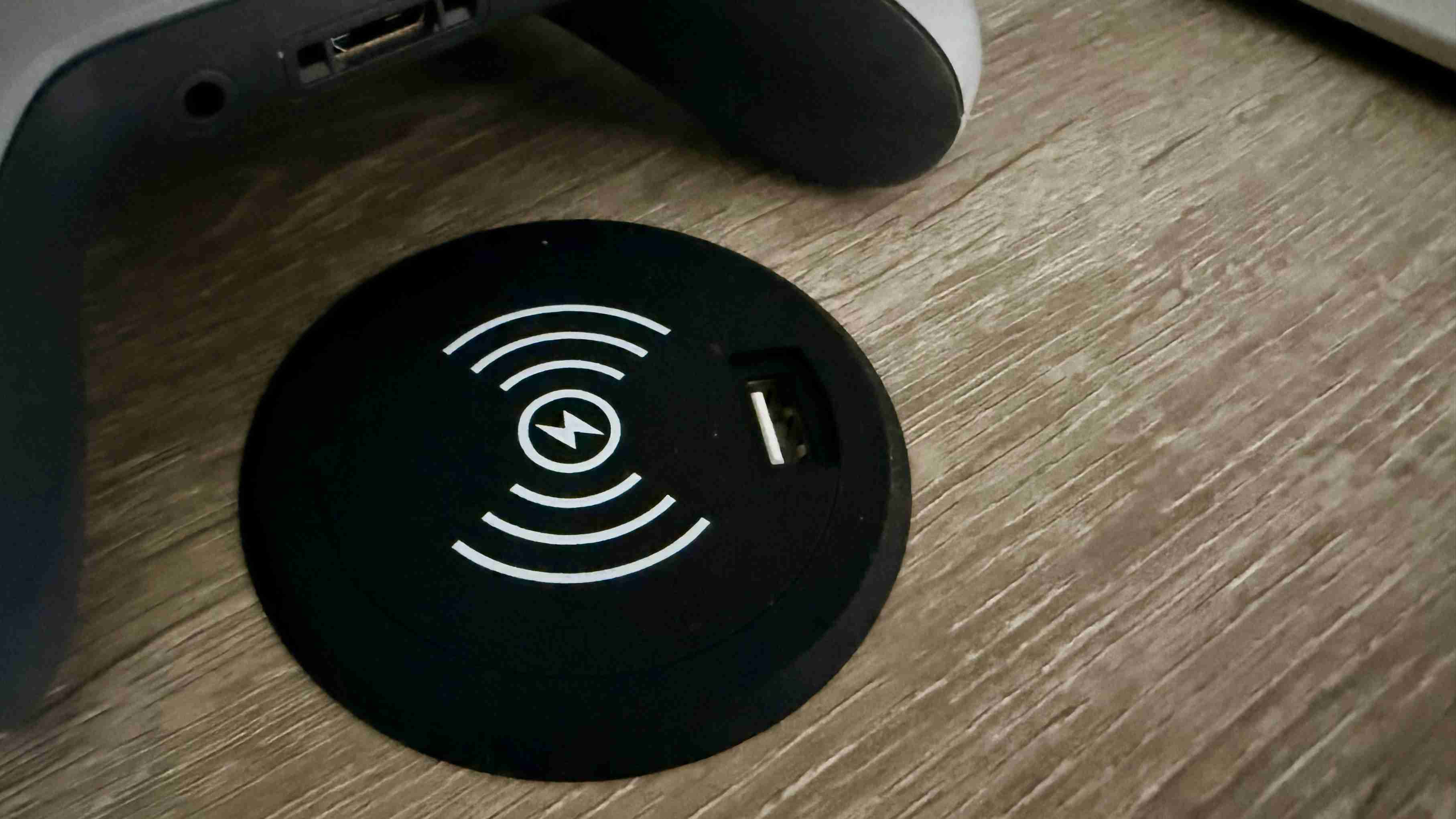 The desk's charging grommet and USB socket, pictured separately from the wider desk view. Image: Collin Probst / Future.