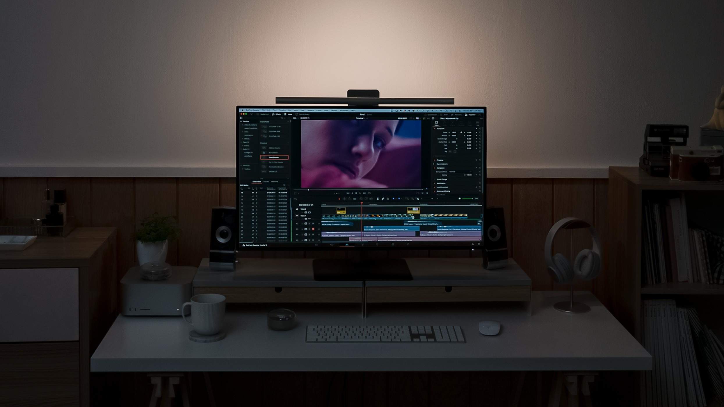 A promoted BenQ ScreenBar Halo 2 desk arrangement with front task light and a wall glow behind the monitor. This is sponsored product imagery.